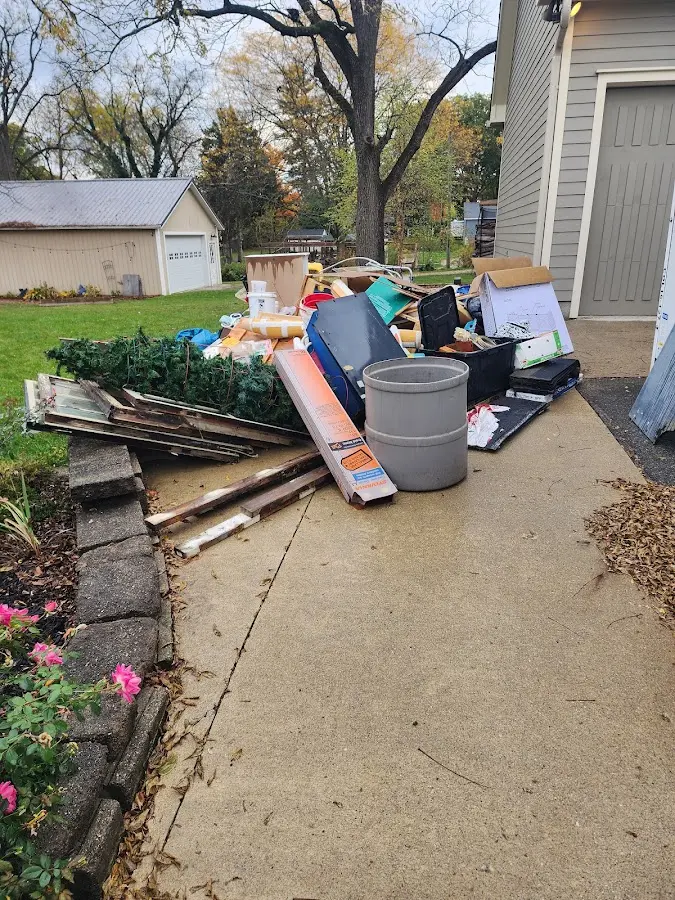 Dumpster being loaded with debris for Estate Cleanout Dumpster Rental in Juno Beach